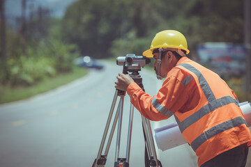 Surveyor engineers work on road construction.