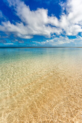 Tropical beach with blue sky and water ripples on a sandy beach