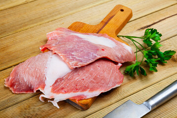 Raw slice of Iberian pork secret and parsley