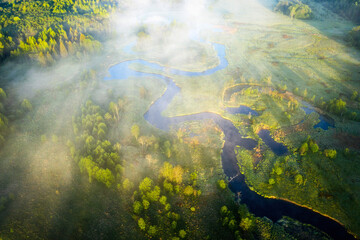 Natural landscape aerial view. Summer beautiful scenery in early morning. Brightly sunshine above misty river and meadow 