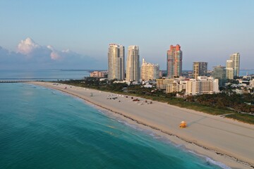 Obraz premium Aerial view of South Pointe Park and South Beach in Miami Beach, Florida at sunrise with Port Miami and City of Miami skyline in background.