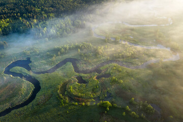 Fototapeta na wymiar Summer landscape. Scenic aerial view. Fabulous early morning above foggy river and green forest.