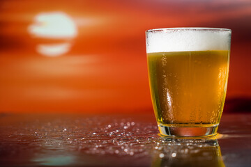Glass of beer on a sunset
