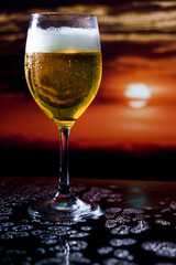 Glass of beer on a sunset