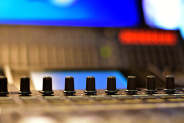 Closeup Analog sound mixer with selected focus. Professional audio mixing console broadcasting.