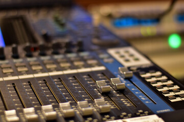 Closeup Analog sound mixer with selected focus. Professional audio mixing console broadcasting.