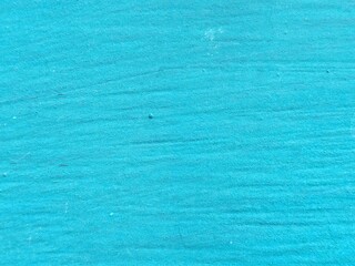Blue cement wall surface. Rough marks on the concrete floor.