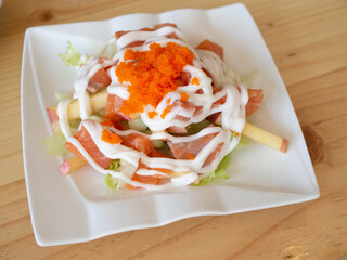 Salmon salad Japanese food on white dish.