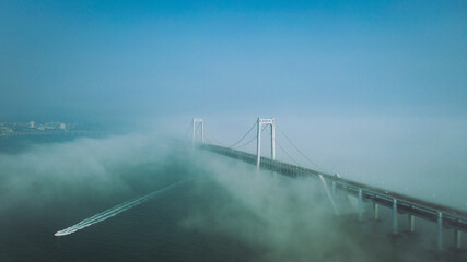 Cross sea bridge under cloud and fog