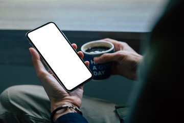 cell phone mockup image blank white screen.woman hand holding texting using mobile on desk at coffee shop.background empty space for advertise.work people contact marketing business,technology