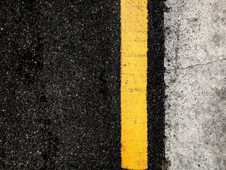 asphalt road with yellow lines
