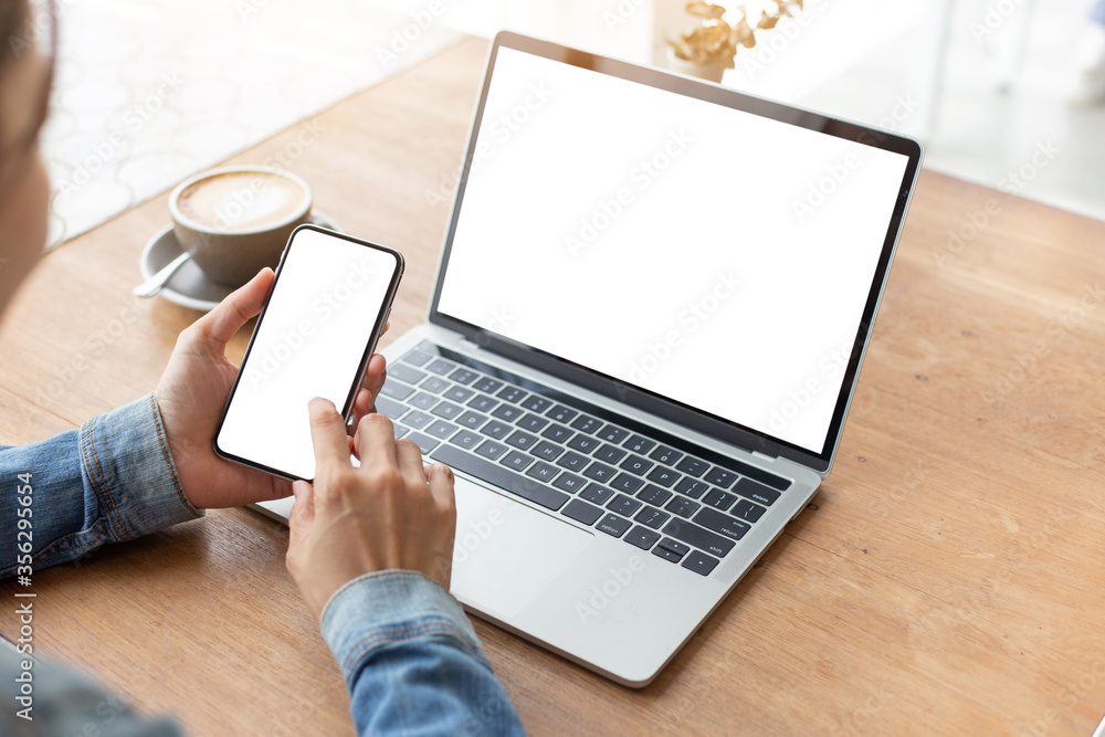 Canvas Prints computer,cell phone mockup image.hand woman work using laptop texting mobile.blank screen with white background for advertising,contact business search information on desk in cafe.marketing,design