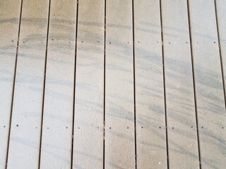 black skid marks or lines on wood deck