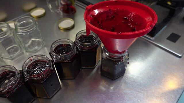 CU Preparing jam in kitchen, filling the jam jars , London, England