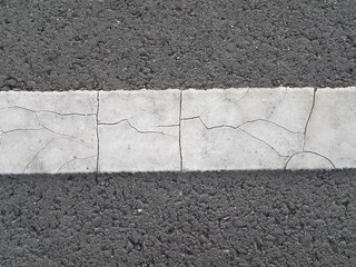 black asphalt with broken white paint line