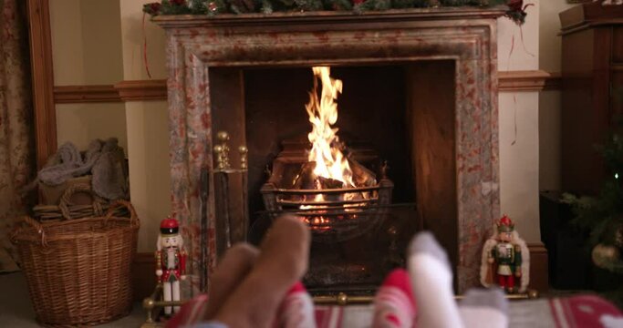 MS TU TD Family with son (6-7) relaxing on sofa near fireplace with Christmas decorations / Dinton, Wiltshire, UK