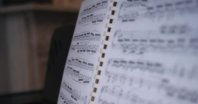 Close up of man annotating sheet music for piano.