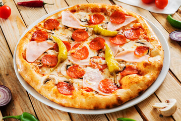 tasty pizza on the wooden background