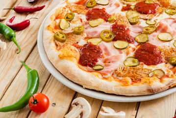 tasty pizza on the wooden background