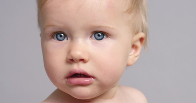 SLO MO CU Baby girl (6-11 months) looking at camera