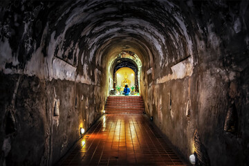 Buddhist praying golden buddha image in the small hall of Wat U Mong Temple, Chiangmai, Thailand