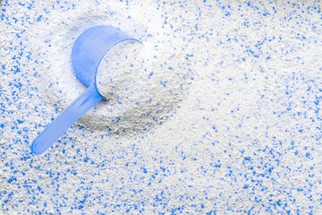 Washing detergents. White wash soap texture with cup for laundry background. Liquid powder in scoop...