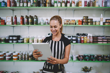 Young Caucasian woman shop owner enjoying entrepreneurship business