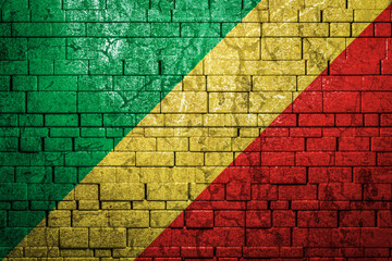 National flag of Republic of the Congo on brick  wall background.The concept of national pride and symbol of the country. Flag  banner on  stone texture background.