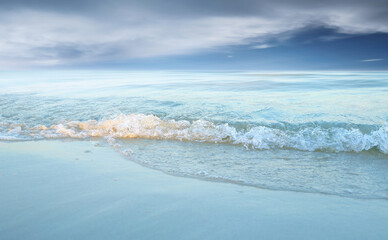 Fototapeta premium Soft wave of the sea on the sandy beach.Summer vacation background.