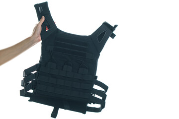 Hand holding bulletproof vest isolated on white background.