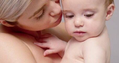 SLO MO CU TU Shirtless mother holding and kissing baby son (6-11 months)