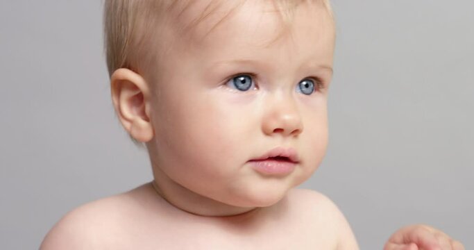SLO MO CU Baby girl (6-11 months) looking at camera