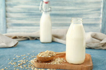 Bottle of tasty oat milk on table