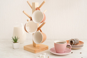 Holder with cups on kitchen table