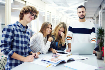 Fototapeta premium Smiling handsome young international students resting after lesson 
