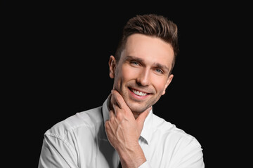 Portrait of handsome businessman on dark background