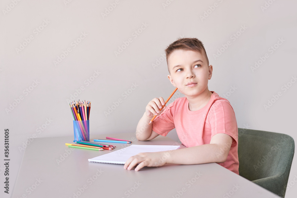 Wall mural little boy drawing. closed locking exercise. homemade routine. school lessons. write pencil on piece