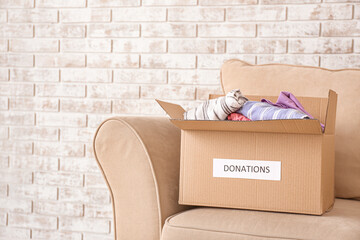 Box with donations on sofa