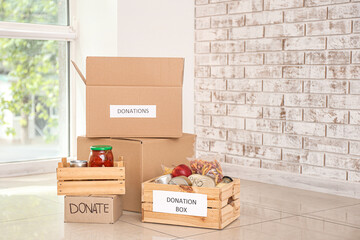 Boxes with donations on floor in room