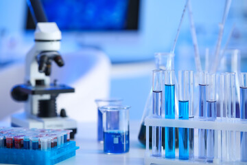 Microscope and glassware on table in laboratory