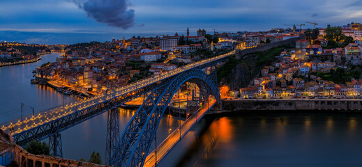 Panoramic sunset view of Porto Portugal cityscape with Dom Luis I Bridge and Douro River