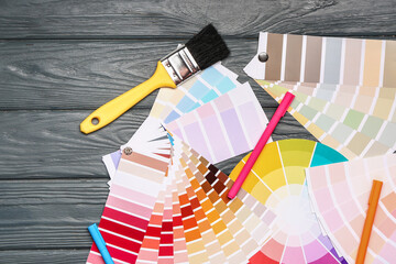 Color palettes with paint brush on wooden background