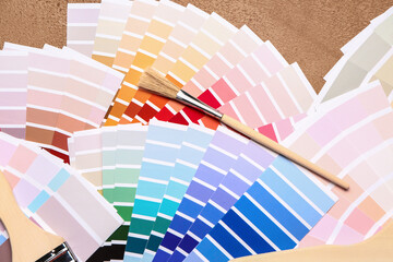 Color palettes with paint brush on brown background