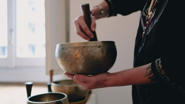 CU Woman playing rin gong / Milan, Italy