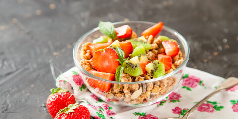 muesli with fruit in a bowl on a table, selective focus, copy space