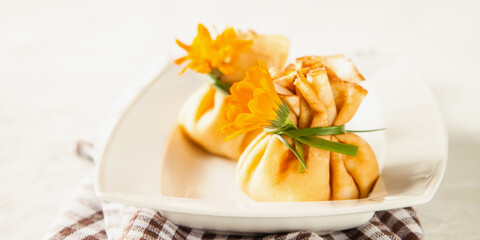 pancake sacks with a cottage cheese and fruit stuffing in a plate on a table, selective focus, copy...
