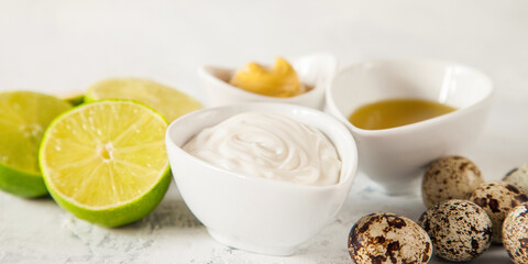 homemade mayonnaise and ingredients - a lime, olive oil, quail eggs and mustard, selective focus, copy space