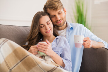 Young happy couple having morning coffee and looking romantic