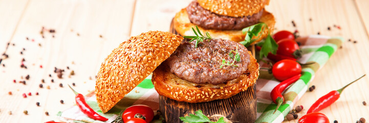 Cutlets for hamburgers and spice on a board. Selective focus. Copy space.
