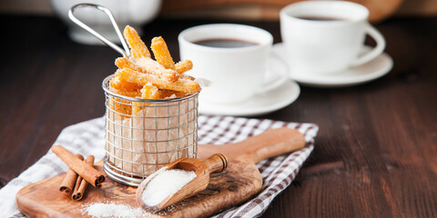 Spanish dessert: churros and tea on the table. Selective focus. Copy space.